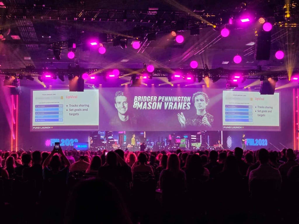 Bridger Pennington and Mason Vranes presenting UpViral on stage at a conference