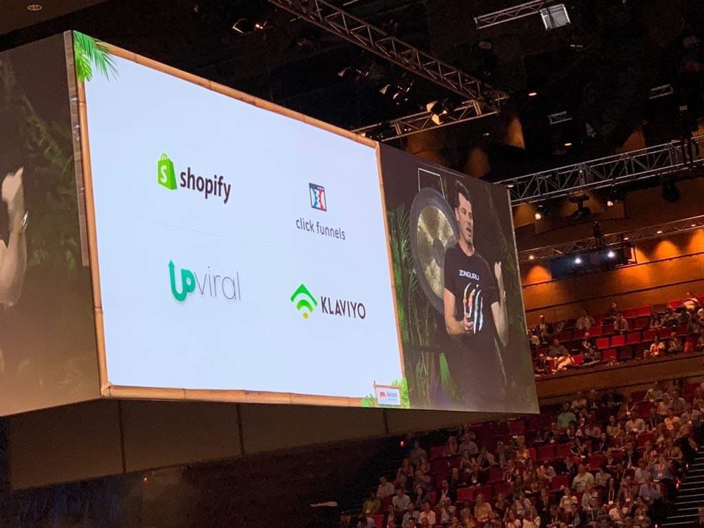 UpViral and Connectio featured on a giant screen on stage at a marketing conference
