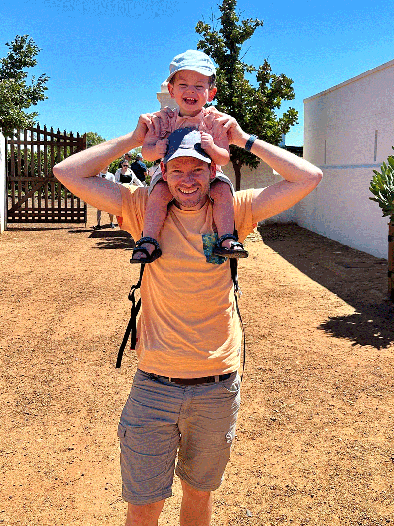 Wilco carrying his daughter on his shoulders